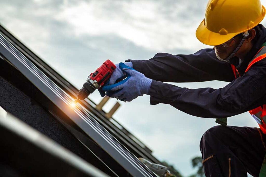 Homeowner inspecting roof shingles with binoculars while a ladder and gutter tools rest nearby.